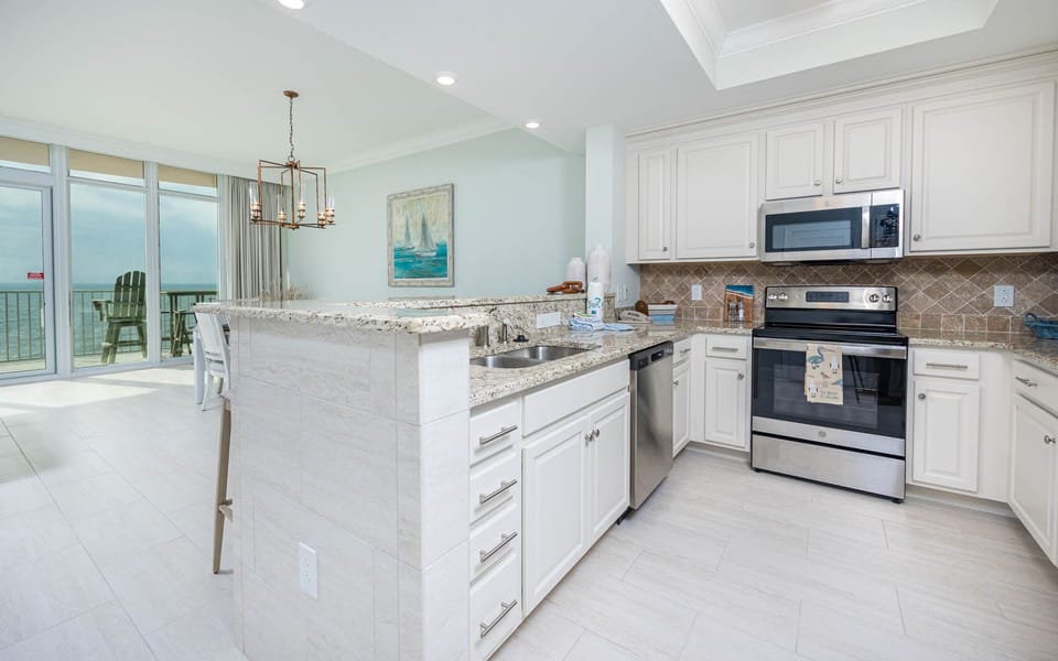 Enjoy cooking in this stylish kitchen with elegant counters, stainless appliances, and tile backsplash