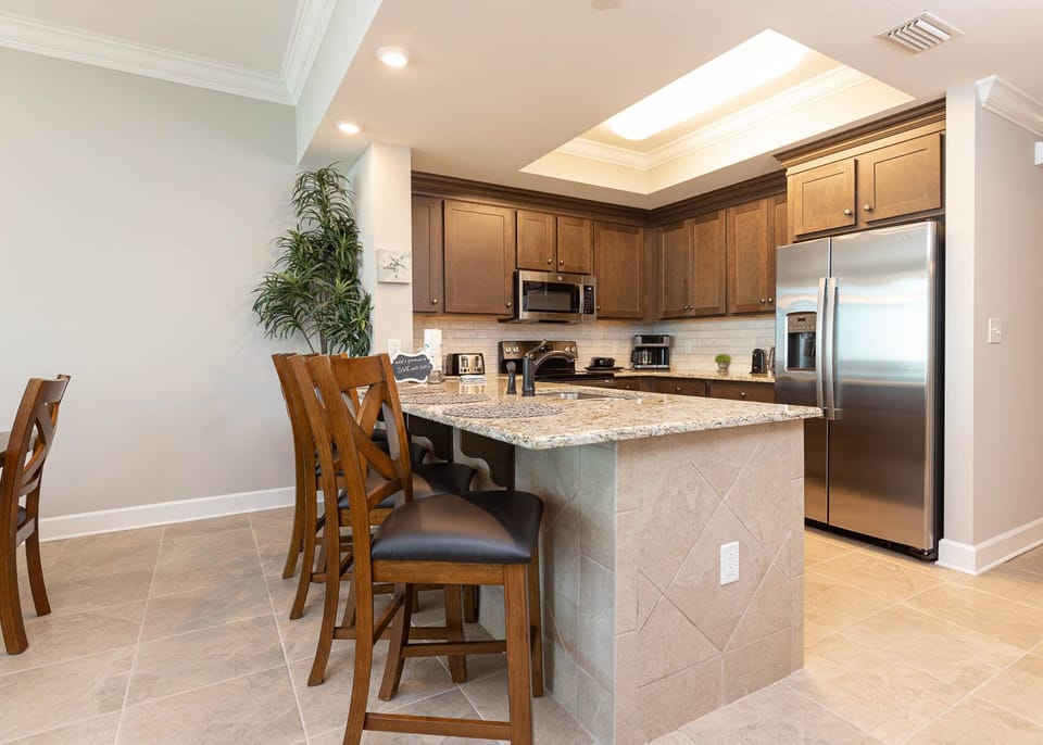 Savor your morning coffee at the breakfast bar and get ready for a beach day in this stylish space