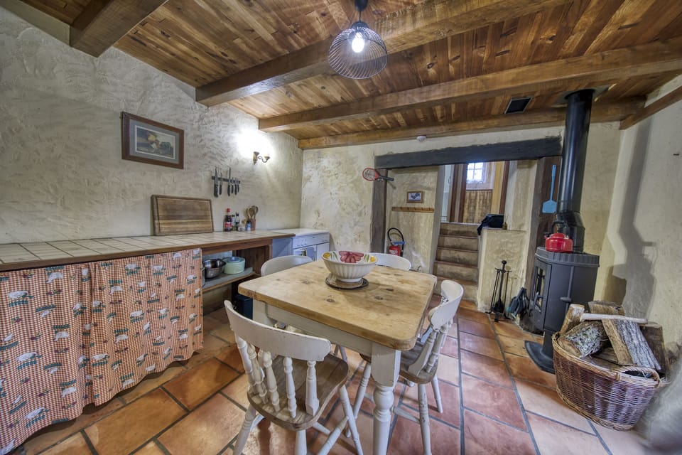 Kitchen with fridge freezer, gas stove, toaster, microwave and log burner