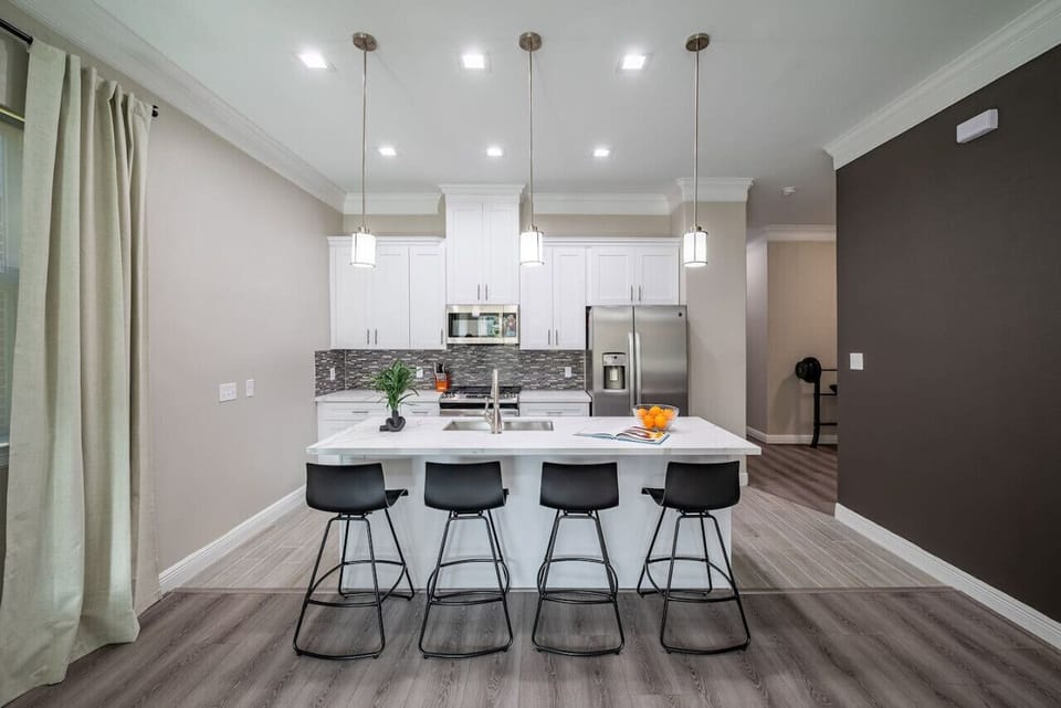 Enjoy a meal on the kitchen island that fits 4 swivel chairs that can be turned around to watch TV.