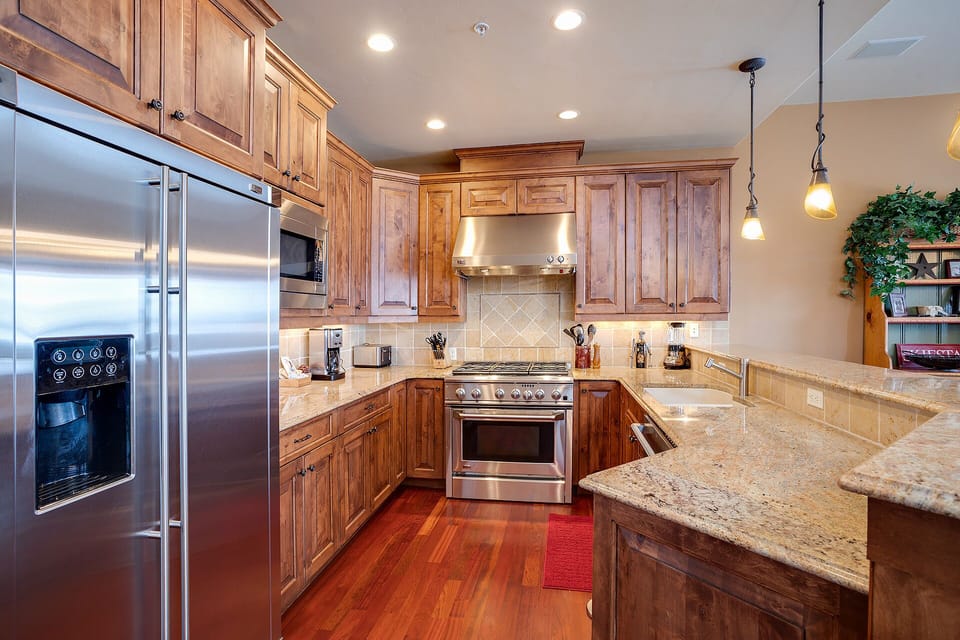 Your gourmet kitchen awaits with granite counters, stainless steel appliances, and rich wood cabinetry for memorable meal prep.