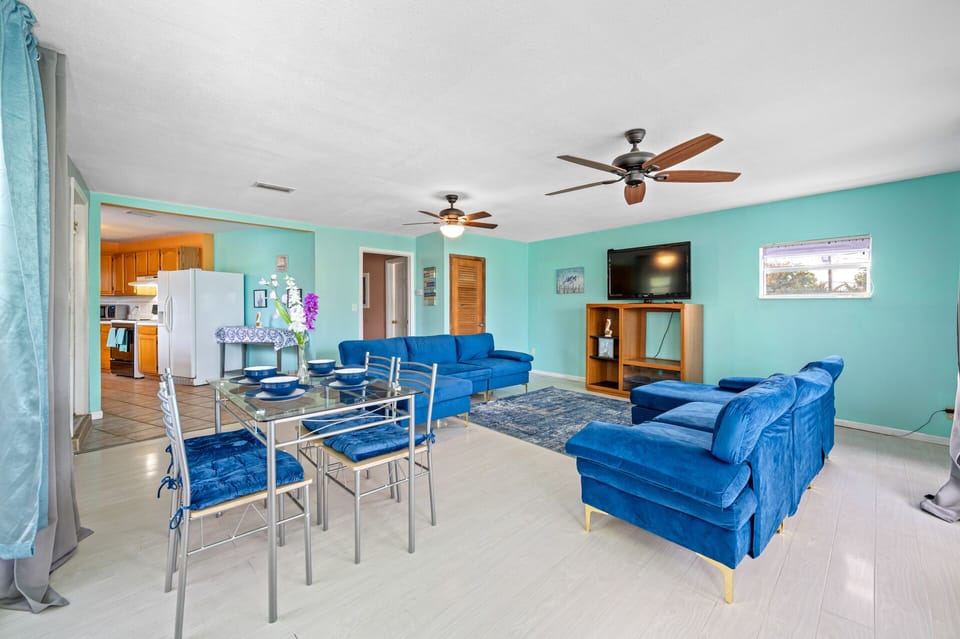 Living room, dining table, roku TV, 2 couches.