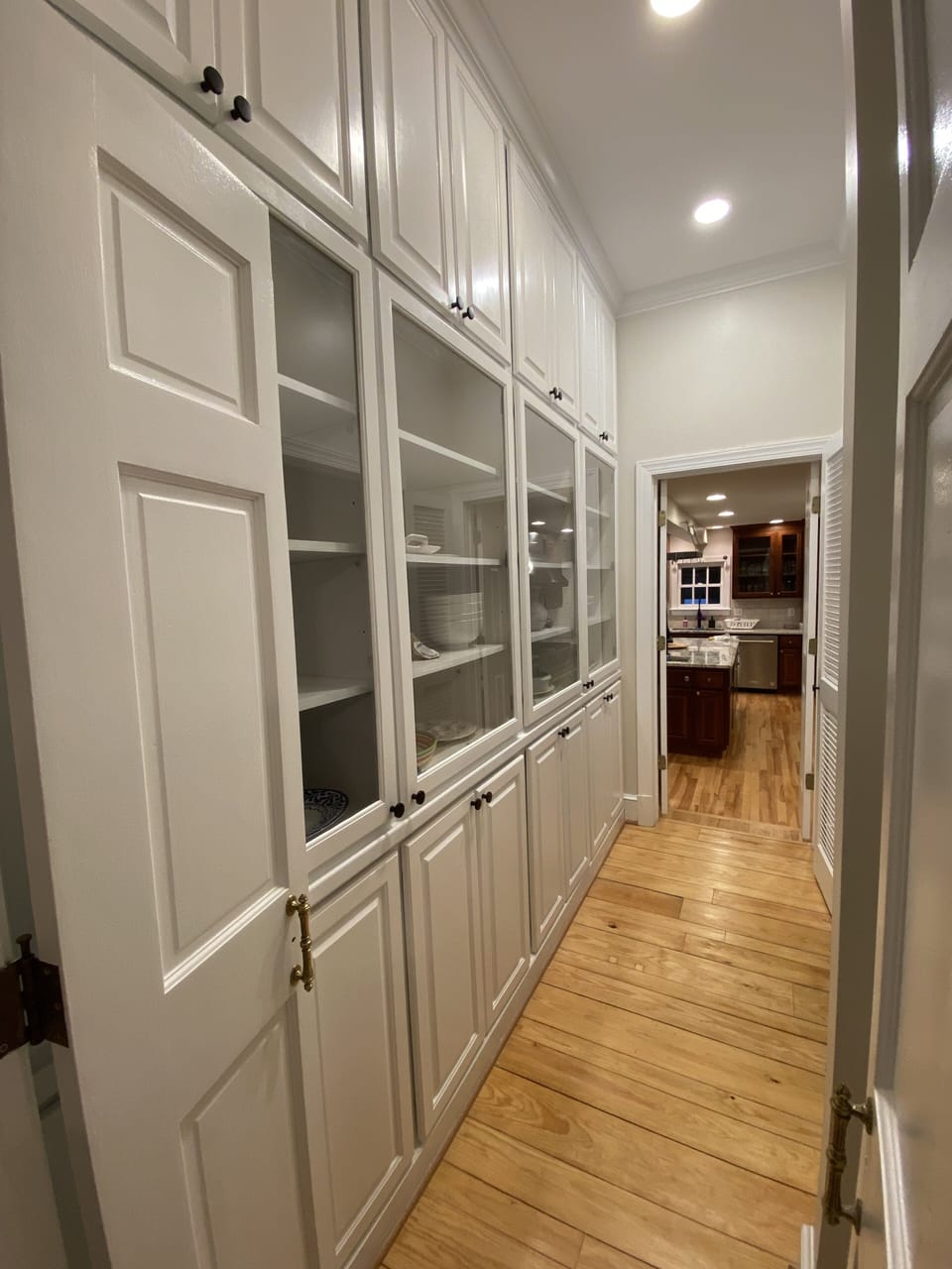Completely stocked Hallway cabinetry adjacent to Butler's kitchen.