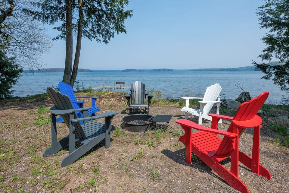 - Lakeside fire pit with colorful Adirondack chairs by the shore - Peaceful setup ideal for morning coffee or sunset chats - Open lake views create a calm scenic gathering experience