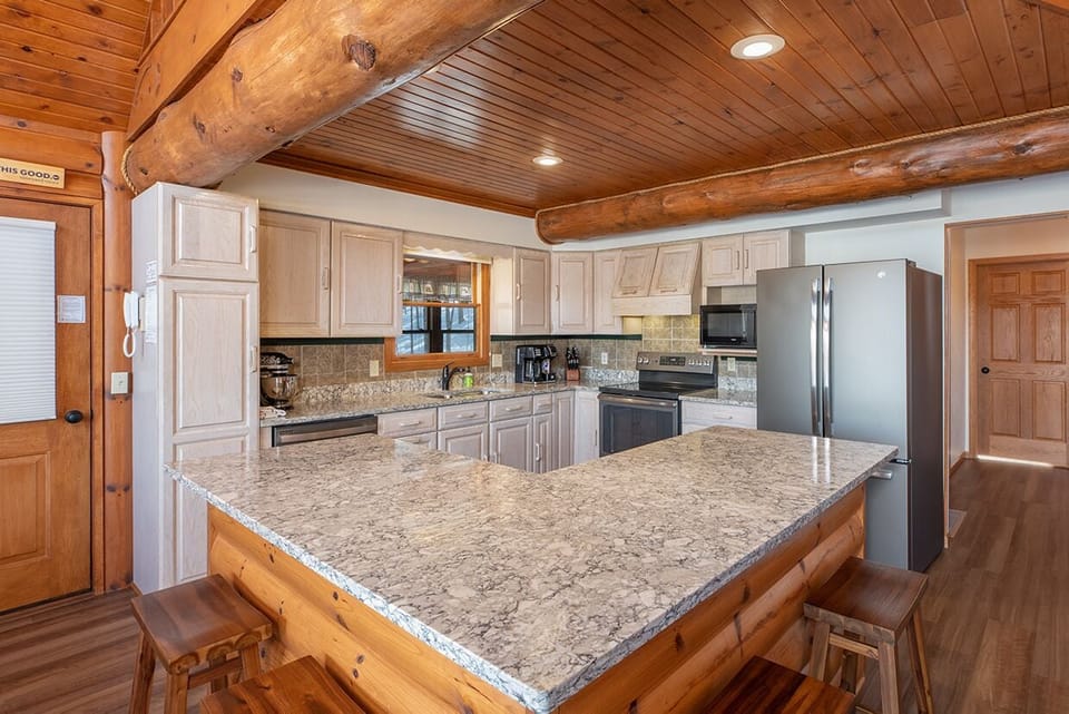 - Modern kitchen with stone counters and full appliances - Perfect for home-cooked meals and shared gatherings - Open design connects living room and peaceful views