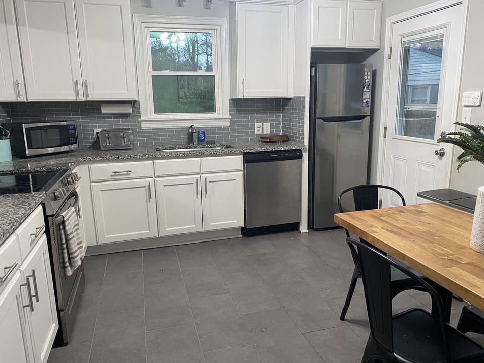 Eat-in kitchen, DW, stove/oven, microwave, coffee maker, toaster and fridge.