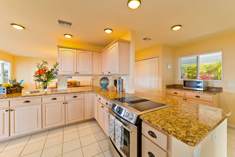 Kitchen with nicely appointed appliances and beautiful granite counter tops
