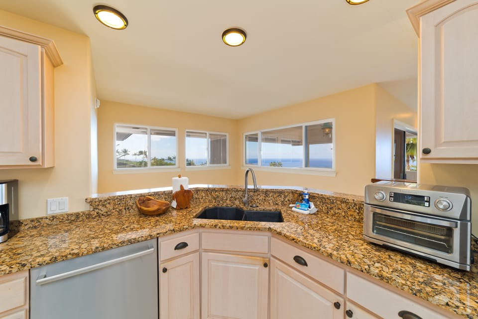 Kitchen with nicely appointed appliances. You will find almost everything, and more, even the most discerning chef might require, from bread maker to a toaster oven for a quick meal options.