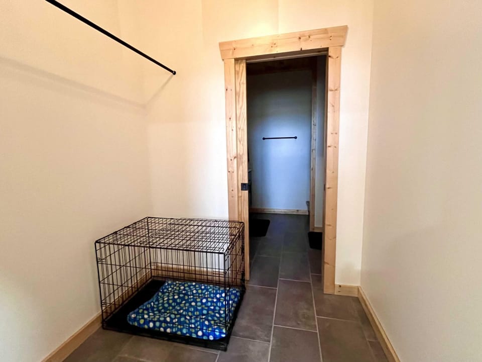 Dog crate and master closet leading into master bath