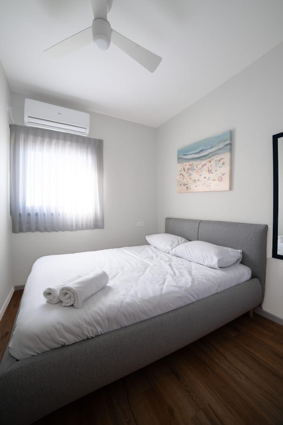 Comfortable bedroom provides peaceful retreat appreciated after vibrant beach days and evening promenade walks nearby.