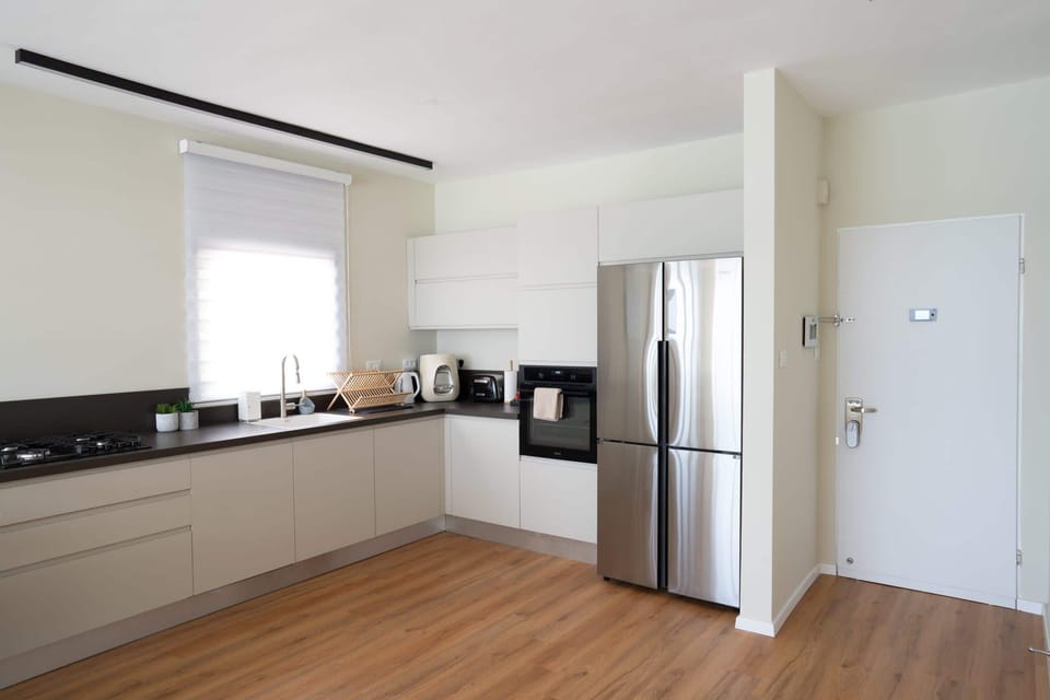 Contemporary kitchen space supports easy meal preparation, highly appreciated during longer family-friendly visits.