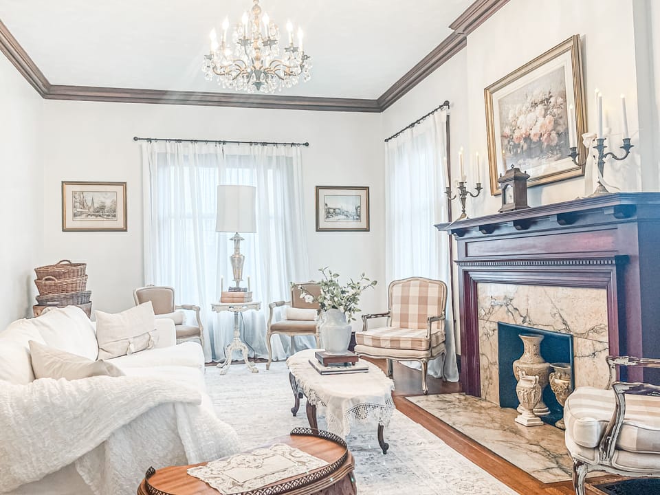 Living room adorned with plush furnishings and exquisite artwork. Natural Sun.