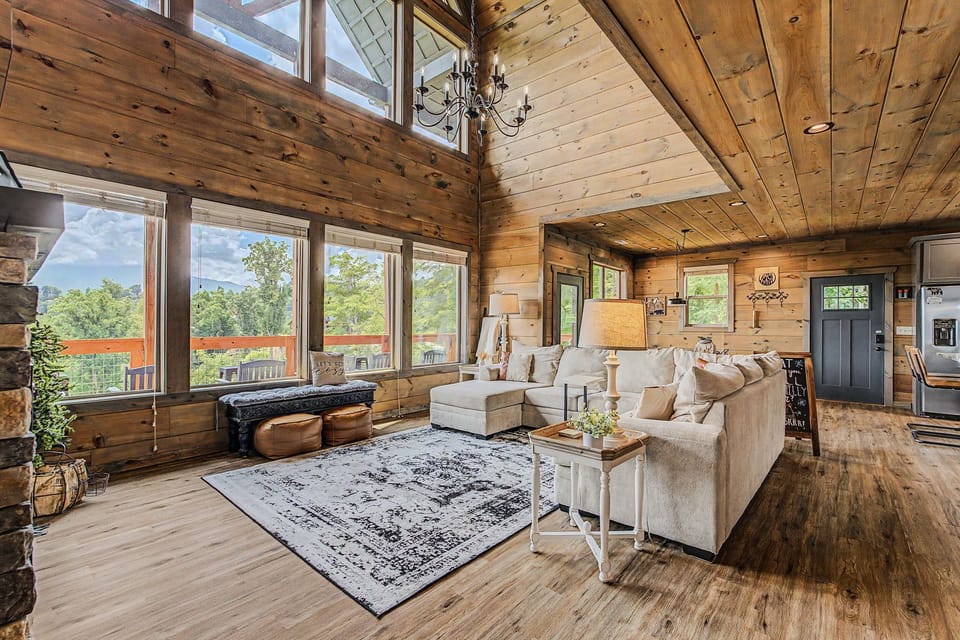 Walls of windows fill the living room with light and mountain views.