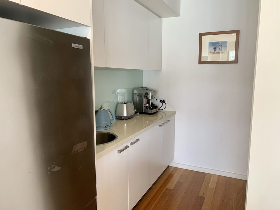 Butler’s pantry with ample shelving , coffee machine and extra sink.