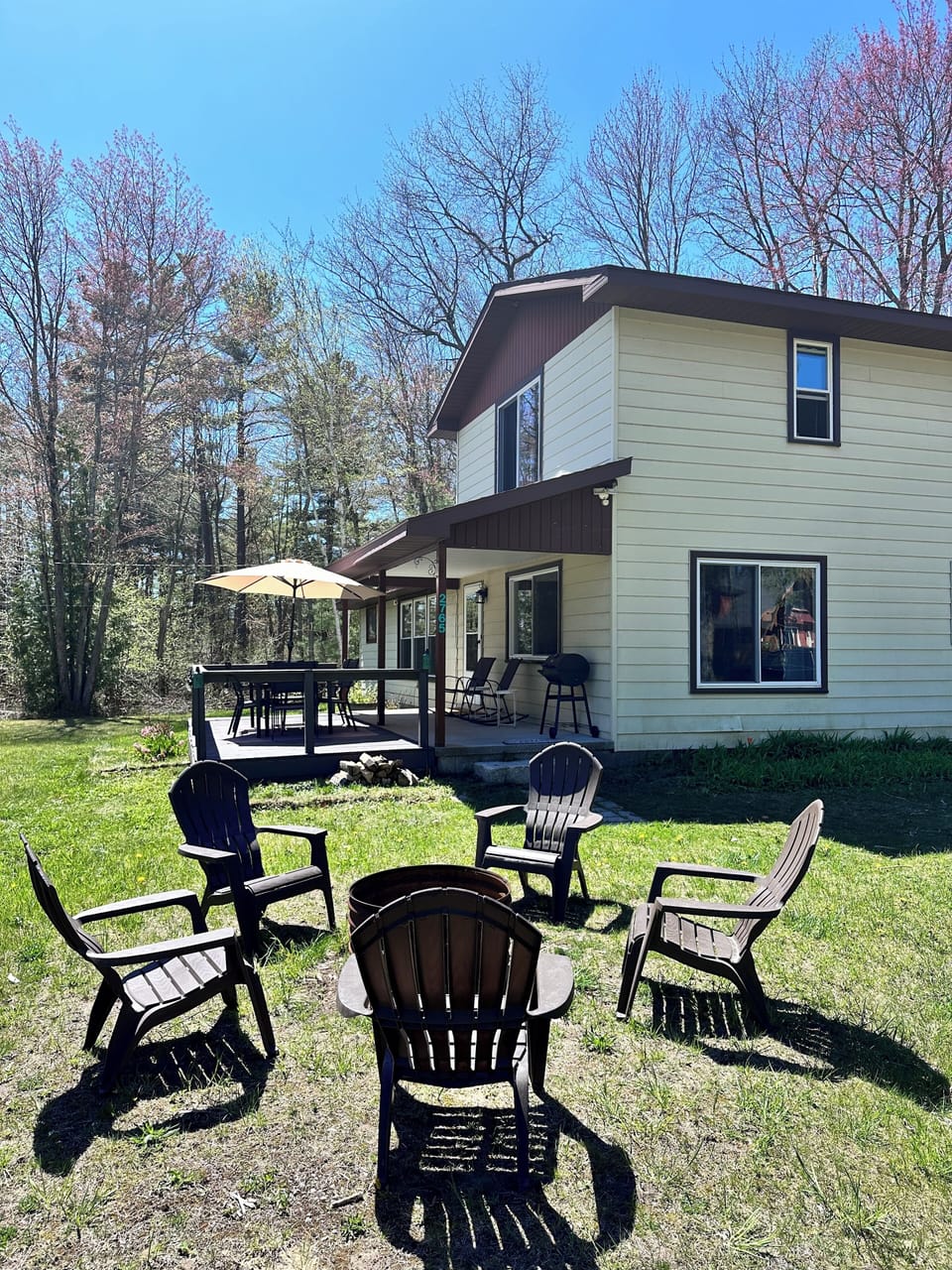 Side view of the house, Adirondack chairs/fire pit.