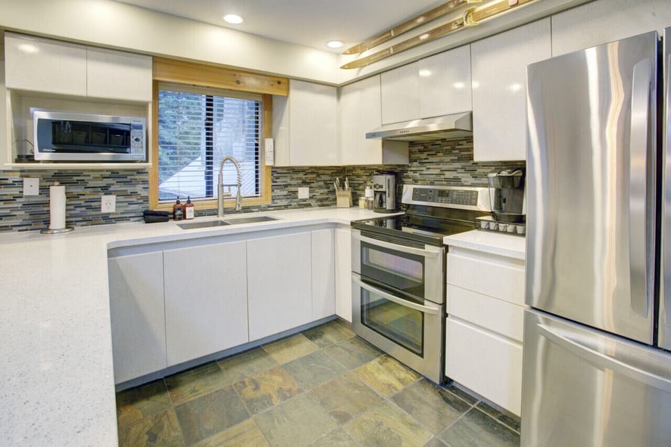Large Fridge, Lots of appliances including Toaster, microwave, oven, stove, kettle, coffee maker  and more.