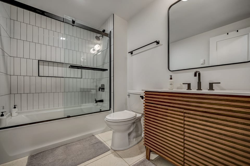 Clean modern full bathroom with tub 