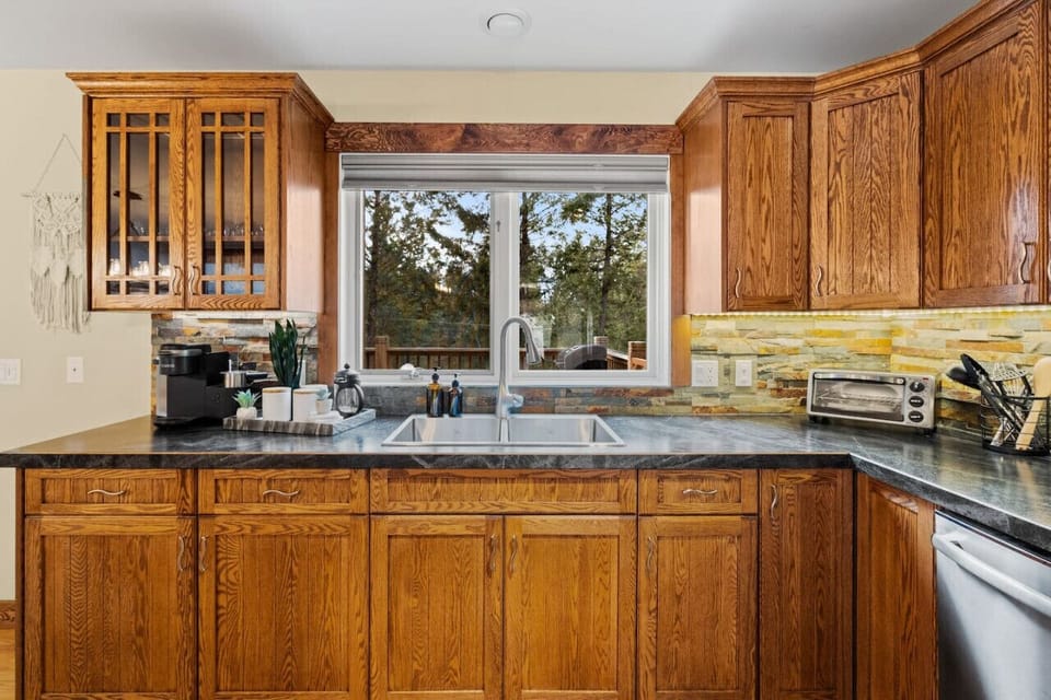 Full kitchen, located on the main floor, with an island and dedicated dining area.