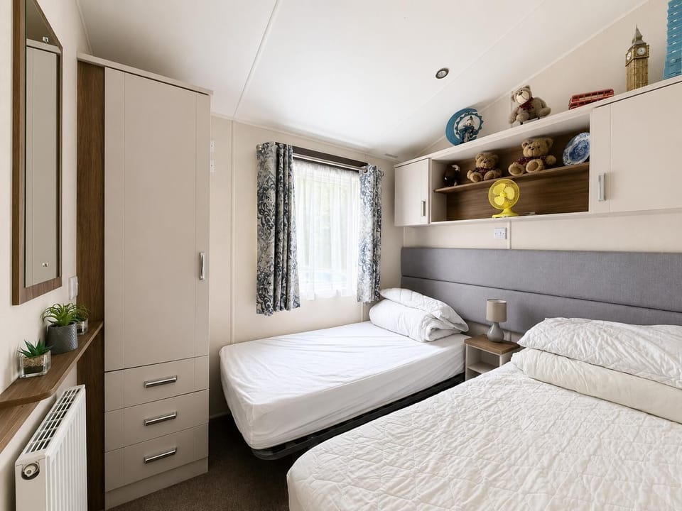 The caravan bedroom provides a snug retreat after a fun day at the beach.