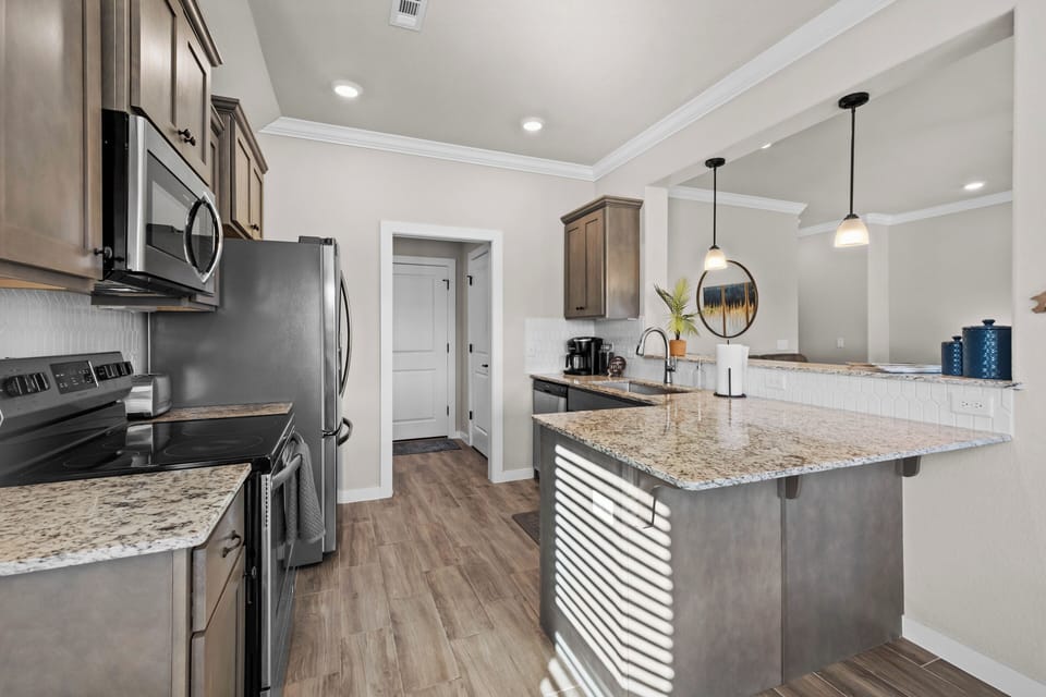 Kitchen leads to laundry room, pantry, & garage with game room!