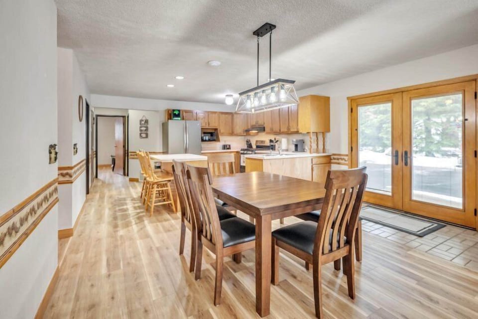 Gather around our expansive kitchen table, perfectly suited for family meals and get-togethers. This welcoming space promotes togetherness, ensuring every meal is both delicious and memorable in our open-concept layout.