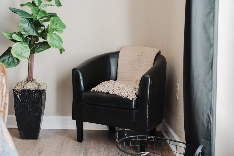 Comfortable sitting chair with indoor plant in the master bedroom at A Sleepy Bear Getaway condo in Pigeon Forge, Tennessee