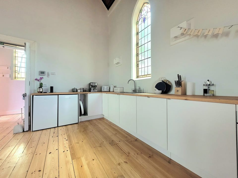 The chef's kitchen with original stained glass windows