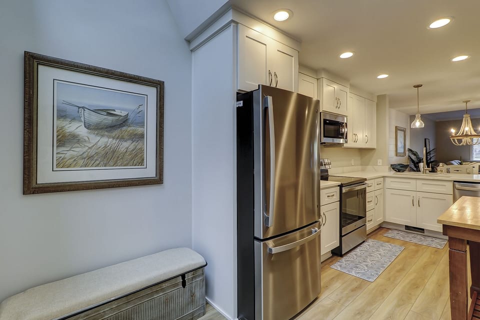 Newly renovated kitchen with all modern appliances including a refrigerator and freezer.