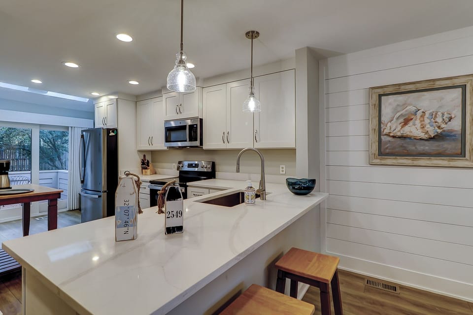 Newly renovated kitchen with seating at the spacious bar.
