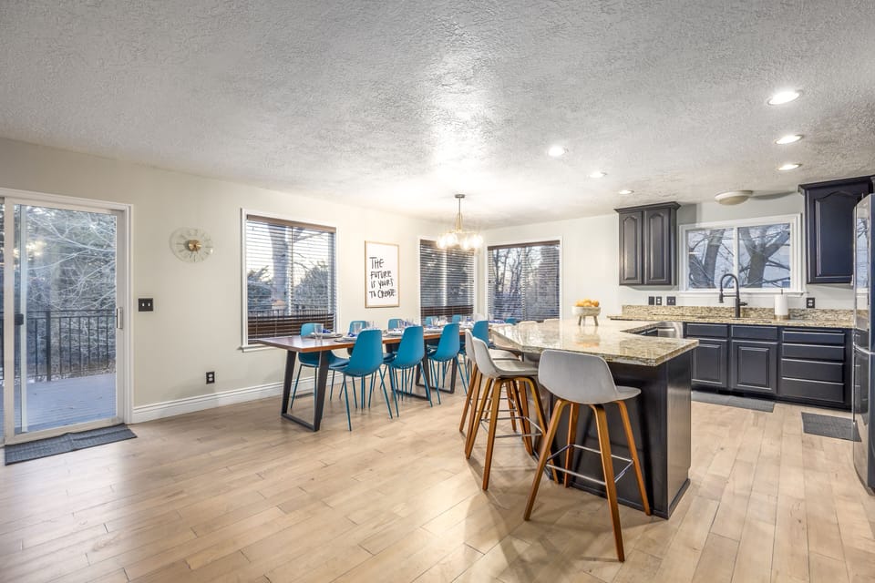 The kitchen and dining area are equipped with seating for 10, and 6 at the bar.