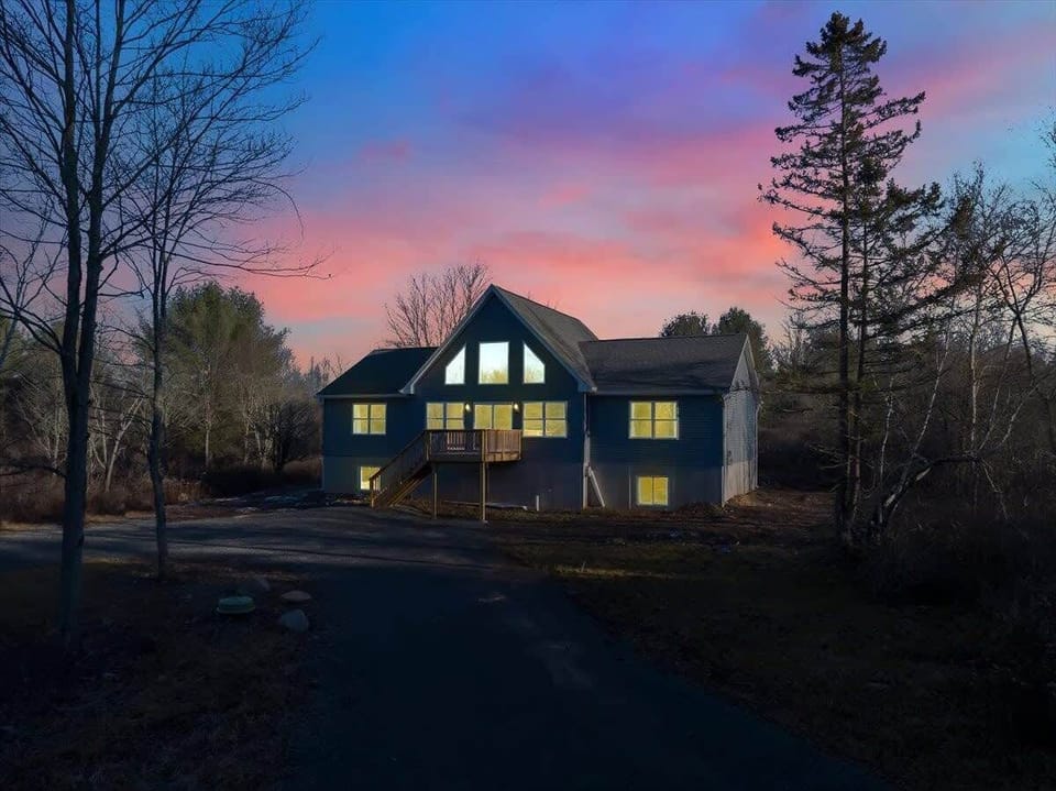 Stunning Cabin Exterior at Sunset with Warm Lighting