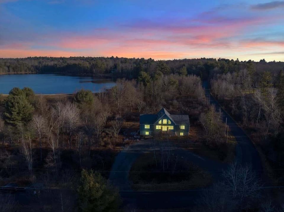 Aerial Sunset View of Secluded Cabin by the Lake
