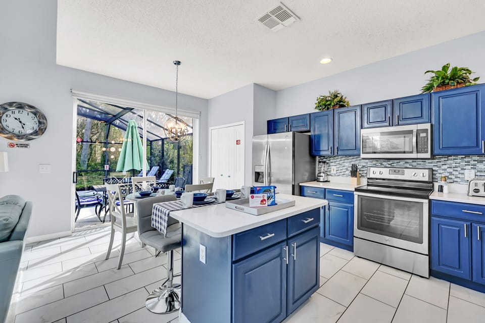 Picturesque Kitchen of the Home in Kissimmee Florida - Fully equipped kitchen - Creates a harmonious and inviting atmosphere - High Chairs and Breakfast bar