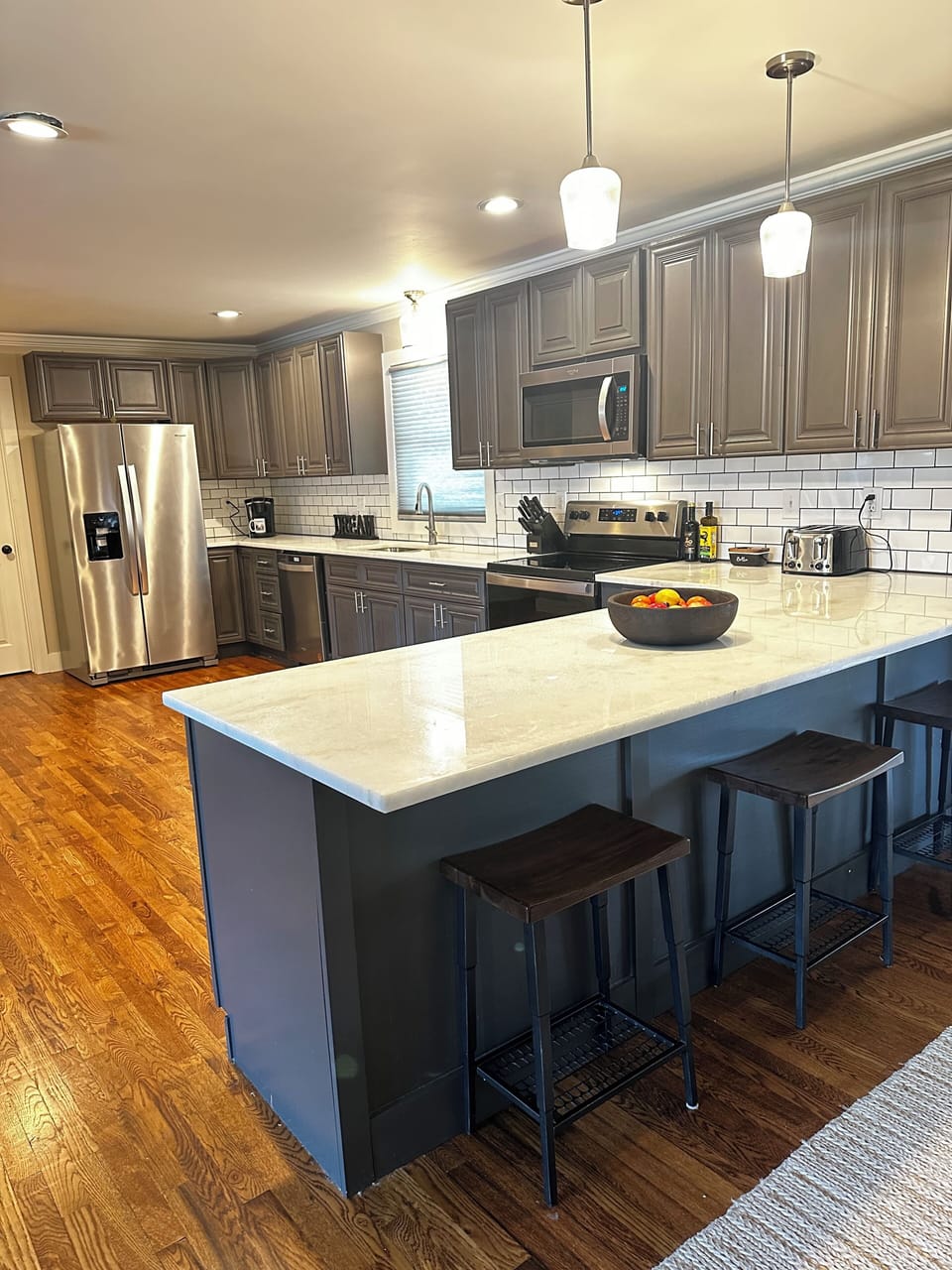 Large open kitchen with bar seating for 3
