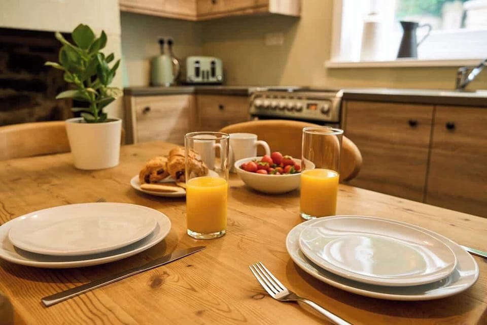 Start your day in a charming kitchen with a cozy dining setup and natural light.