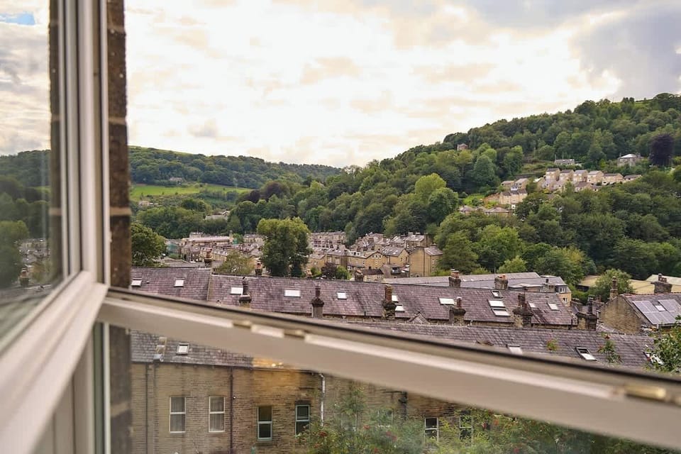 Panoramic Views from the second floor bedroom. The bedroom is three floor up from street level. Locally know as a top and bottom house. Massive windows that open up. Perfect to sit in the window and have a glass of what takes your fancy. 