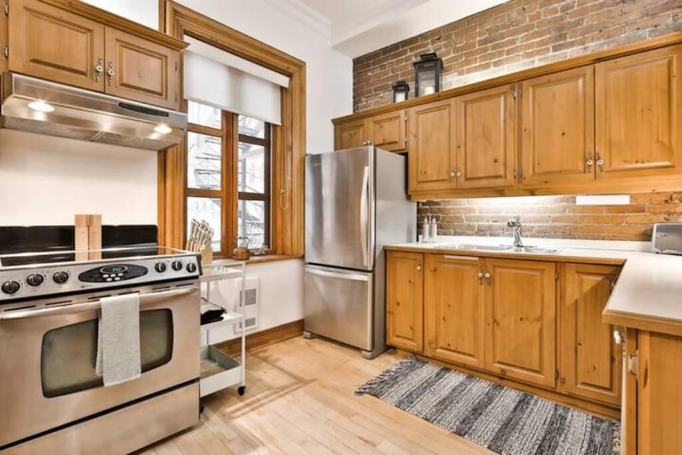 Brick walls add a beautiful charm to the kitchen.