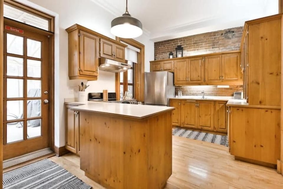 Spacious fully stocked kitchen with access to partially enclosed outdoor deck.