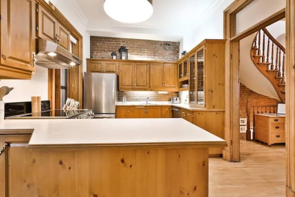 To the right of the kitchen you can see main hallway that leads to a bedroom.