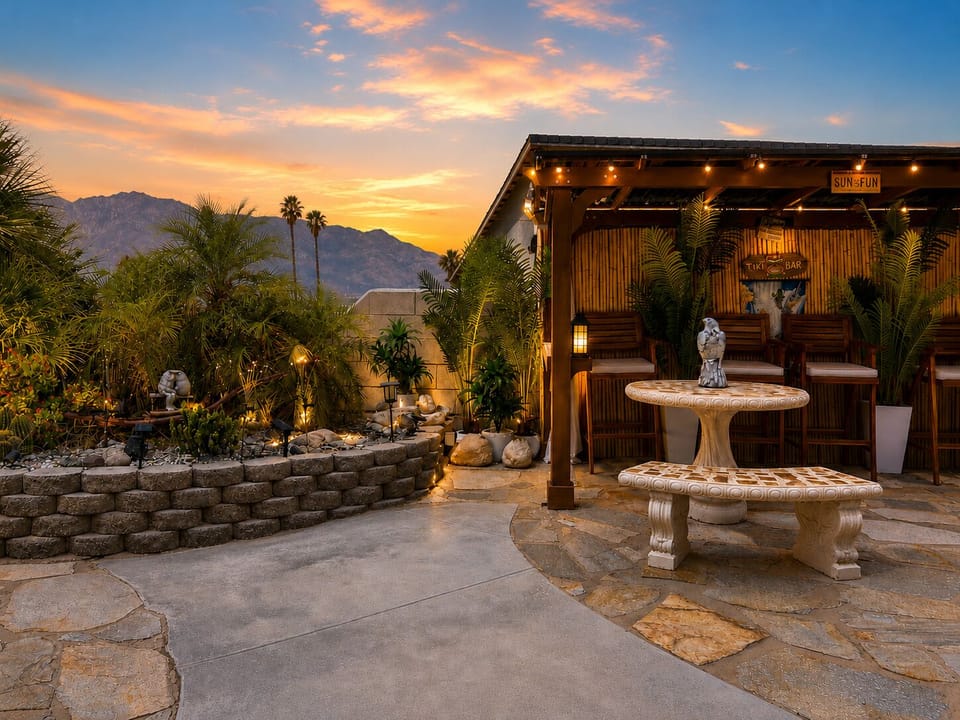 Private tiki bar, tropical garden, mountain views, and glowing desert sunsets