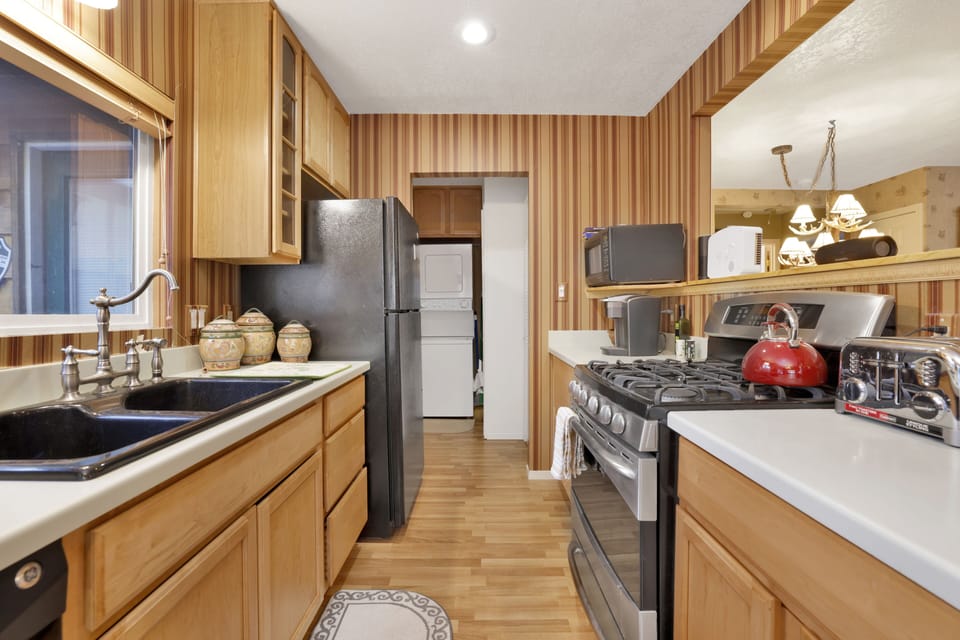 Fully equipped cabin kitchen with ample cabinetry, stove, fridge, microwave, and coffee maker—perfect for cooking meals, morning coffee, and feeling right at home on your stay.