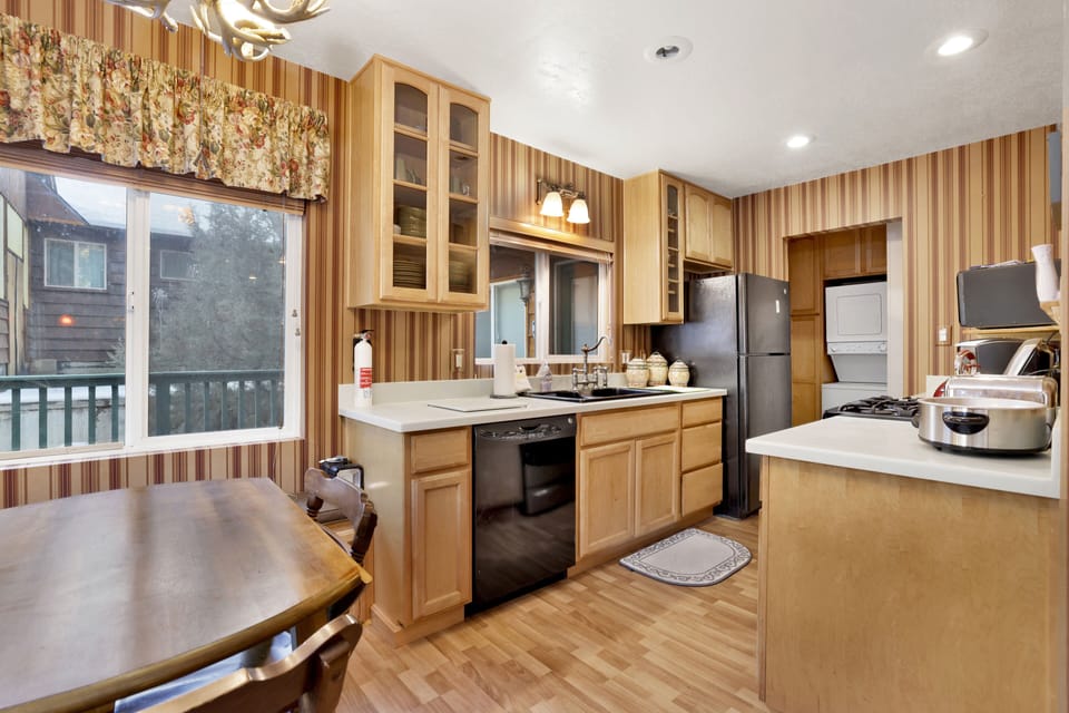 Fully equipped cabin kitchen with ample cabinetry, stove, fridge, microwave, and coffee maker—perfect for cooking meals, morning coffee, and feeling right at home on your stay.