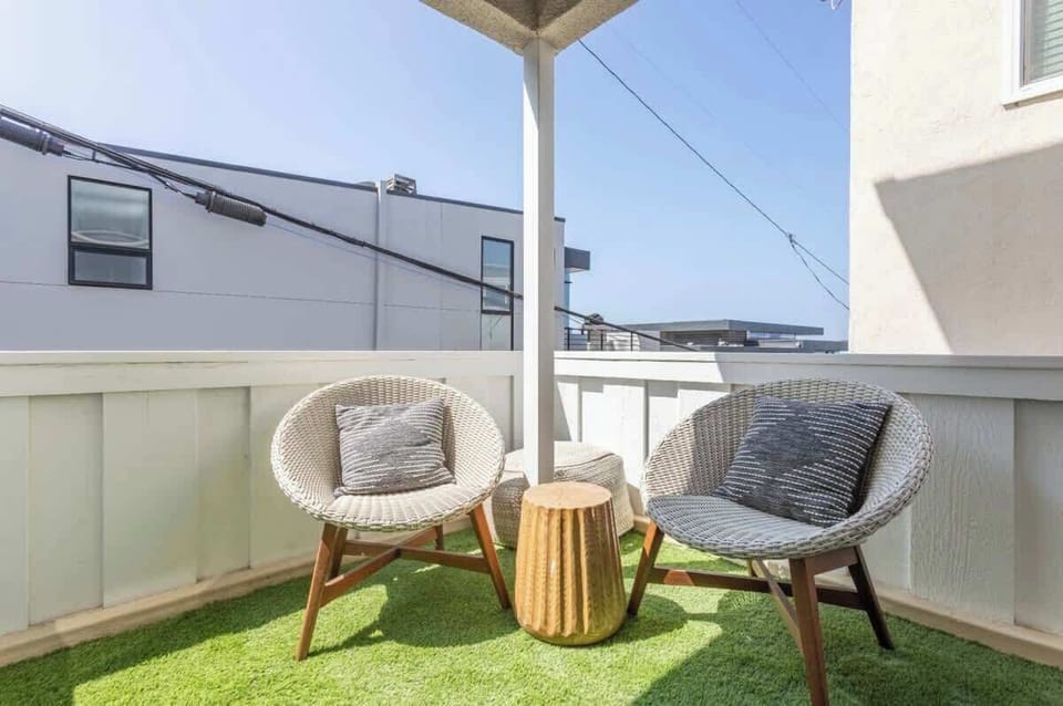 Unwind on your private balcony, featuring a charming bistro set perfect for soaking in the stunning Manhattan Beach views.
