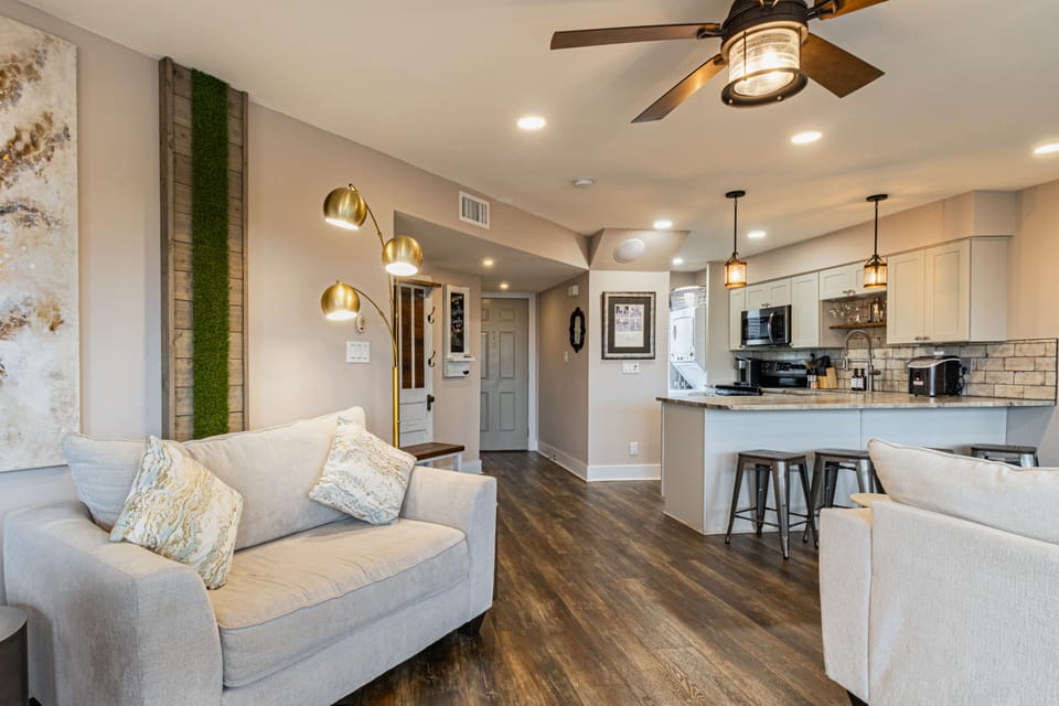 Kitchen features a counter with barstool seating.