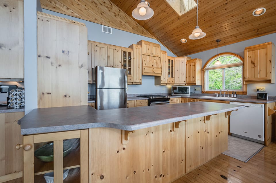 The open concept kitchen and island are within easy reach.