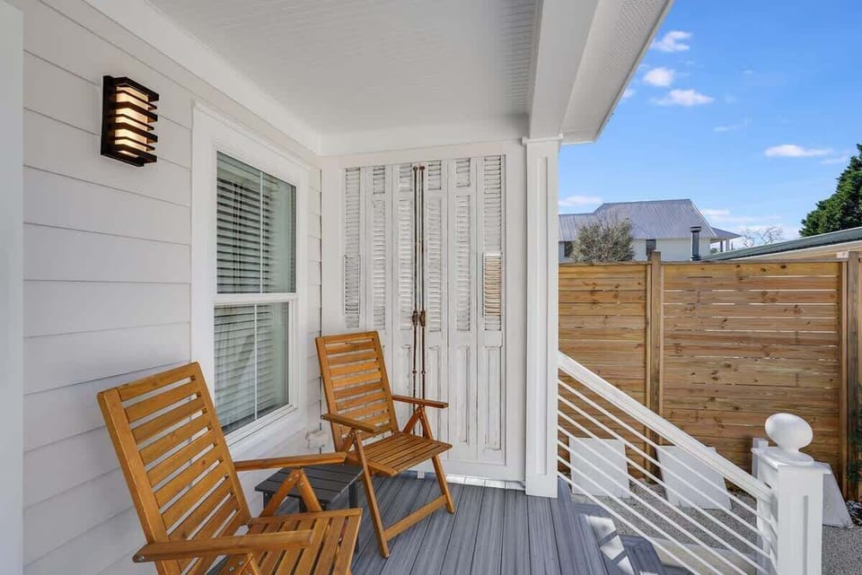 - Welcome home to this charming front porch with classic shutters and cozy wooden seating - Lovely perch for sipping morning coffee or relaxing after beach strolls - Inviting design that blends comfort, character, and curb appeal