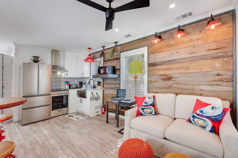 - Bright studio with a rustic wood accent wall, pops of red, &  creative decor - Cook with ease in the fully stocked kitchen featuring a sink & sleek appliances - Cozy seating, eclectic vibes, & clever details make this space feel truly one of a kind