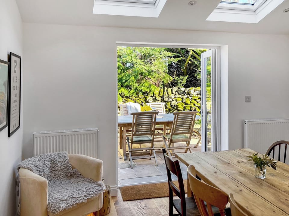 Kitchen french doors open onto enclosed garden patio and dining area | Nurses Cottage, Askham, near Penrith