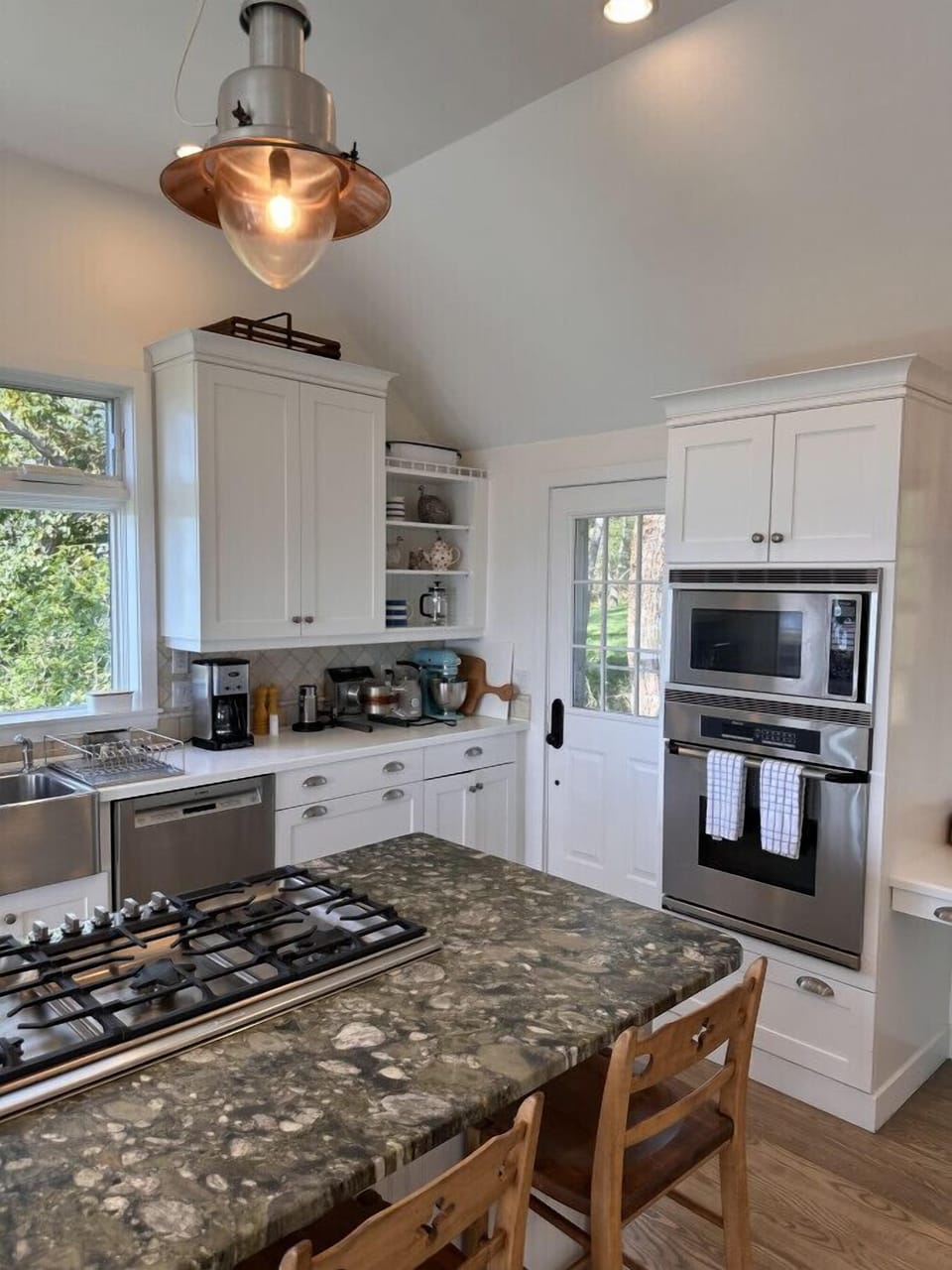 Modern kitchen with island gas range and built in oven