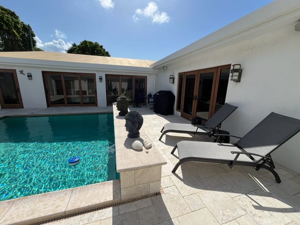 lounge chairs and grill available near your private pool
